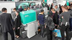 K 2019 attendees look over a new Arburg injection molding machine.