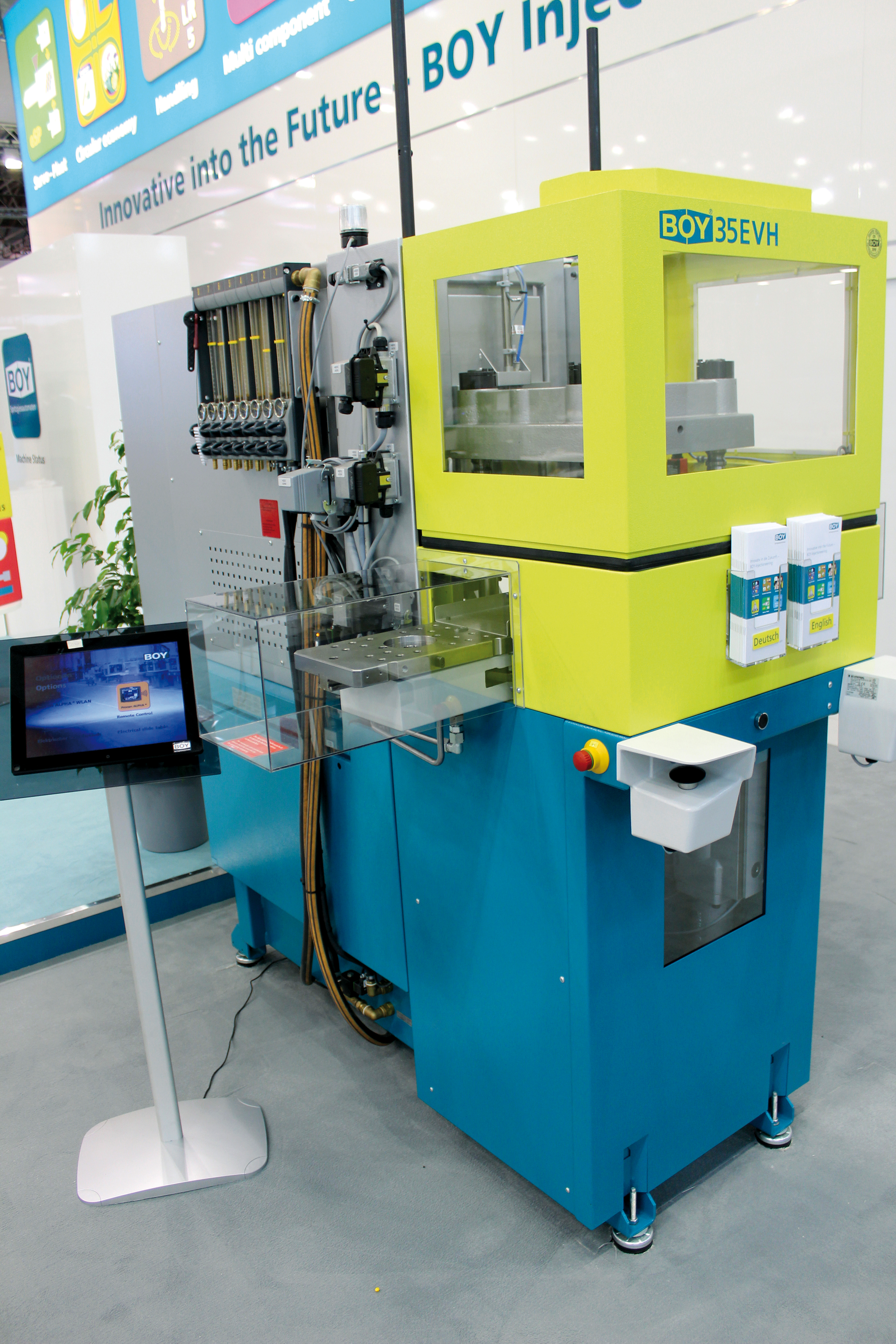 Boy now is offering sliding tables that rotate into and out of the press to simplify overmolding.