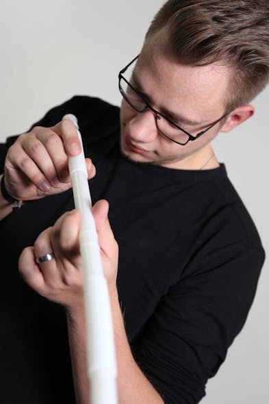 A ProfilControl 7 S CorrugatedTube user examines a plastic tube.