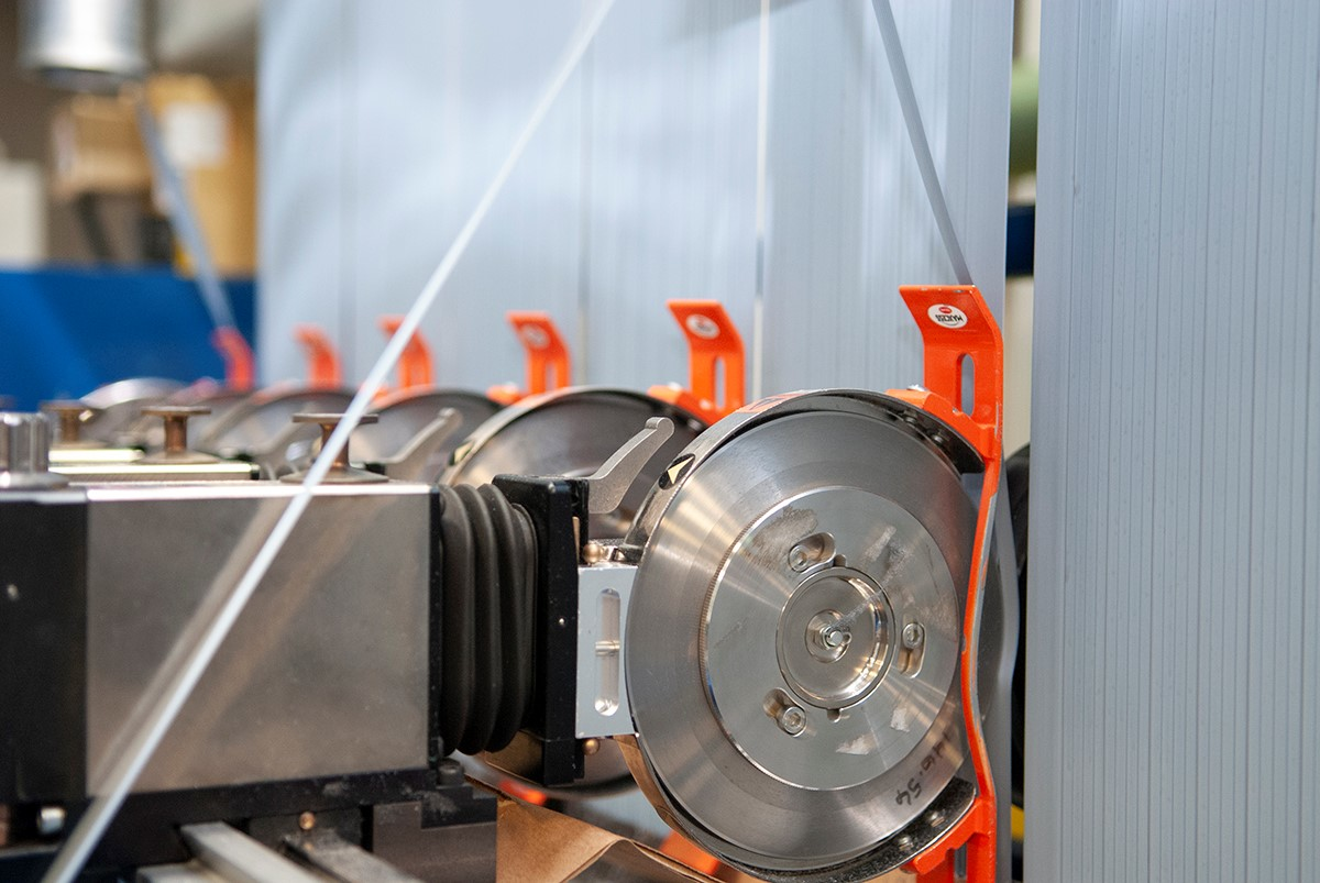 At Entek International, a company-built system transports trim material to a reprocessing station where it is turned back into pellets before being reused.