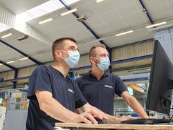 Sepro workers sport masks at the company's headquarters in France. Sepro workers sport masks at the company's headquarters in France.