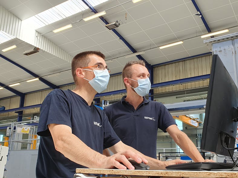 Sepro workers sport masks at the company&apos;s headquarters in France.