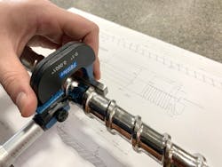 Measuring a screw for wear. Measuring a screw for wear.