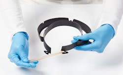 A worker shows how to assemble Evco's face shield. A worker shows how to assemble Evco's face shield.