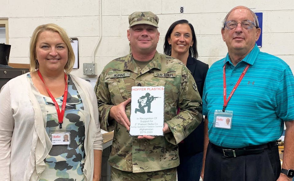 From left, Gretchen Hoffer Farb, chief financial officer of Hoffer Plastics; Army Sgt. Keith Kuhns; Charlotte Hoffer Canning, VP of brand and culture; William Hoffer, chairman. Kuhns is holding a plaque he made and presented to Hoffer Plastics when he returned from Afghanistan.