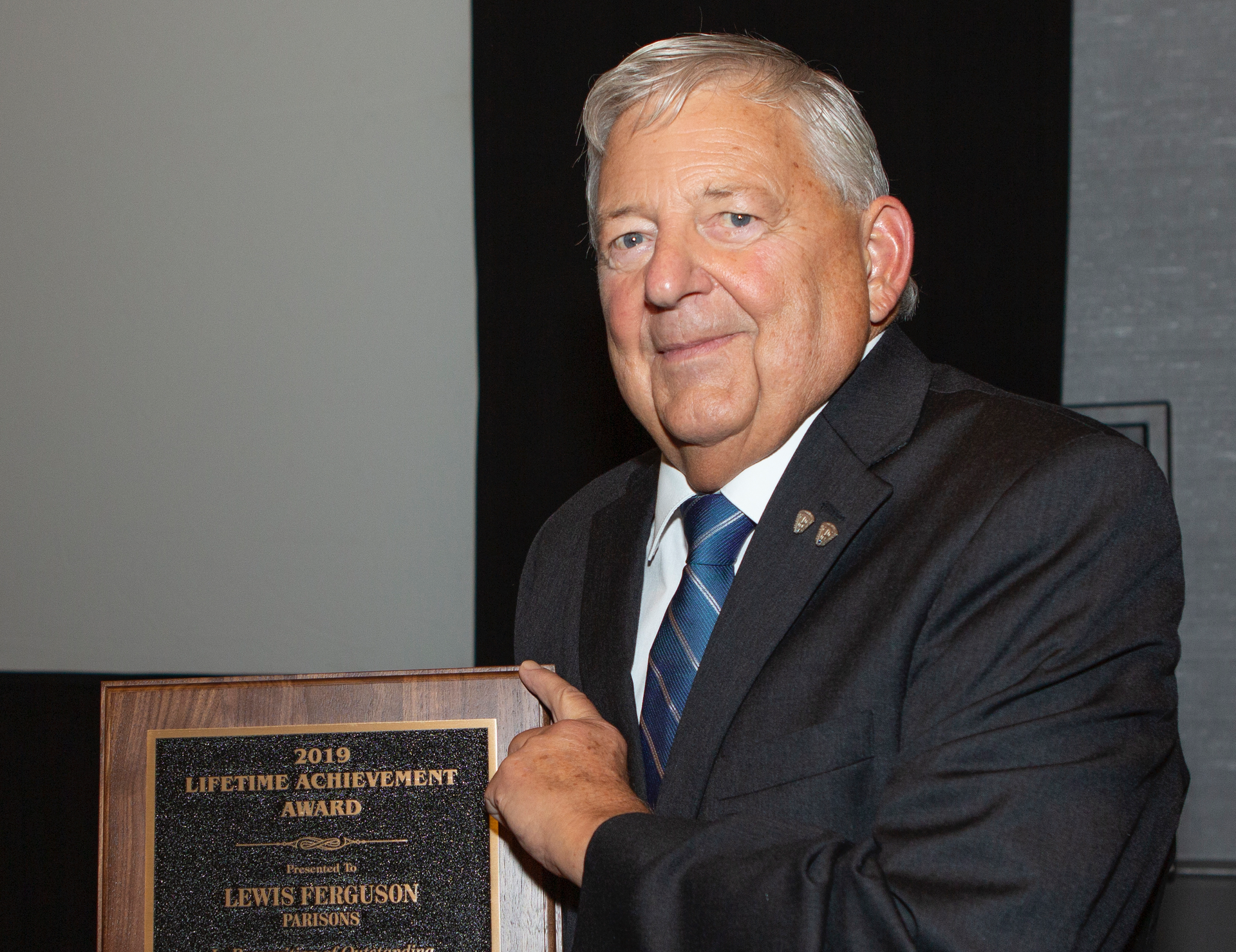 Lew Ferguson holds his 2019 Lifetime Achievement Award. It was presented to him at the Society of Plastics Engineers' Annual Blow Molding Conference. It is the organization's highest honor.