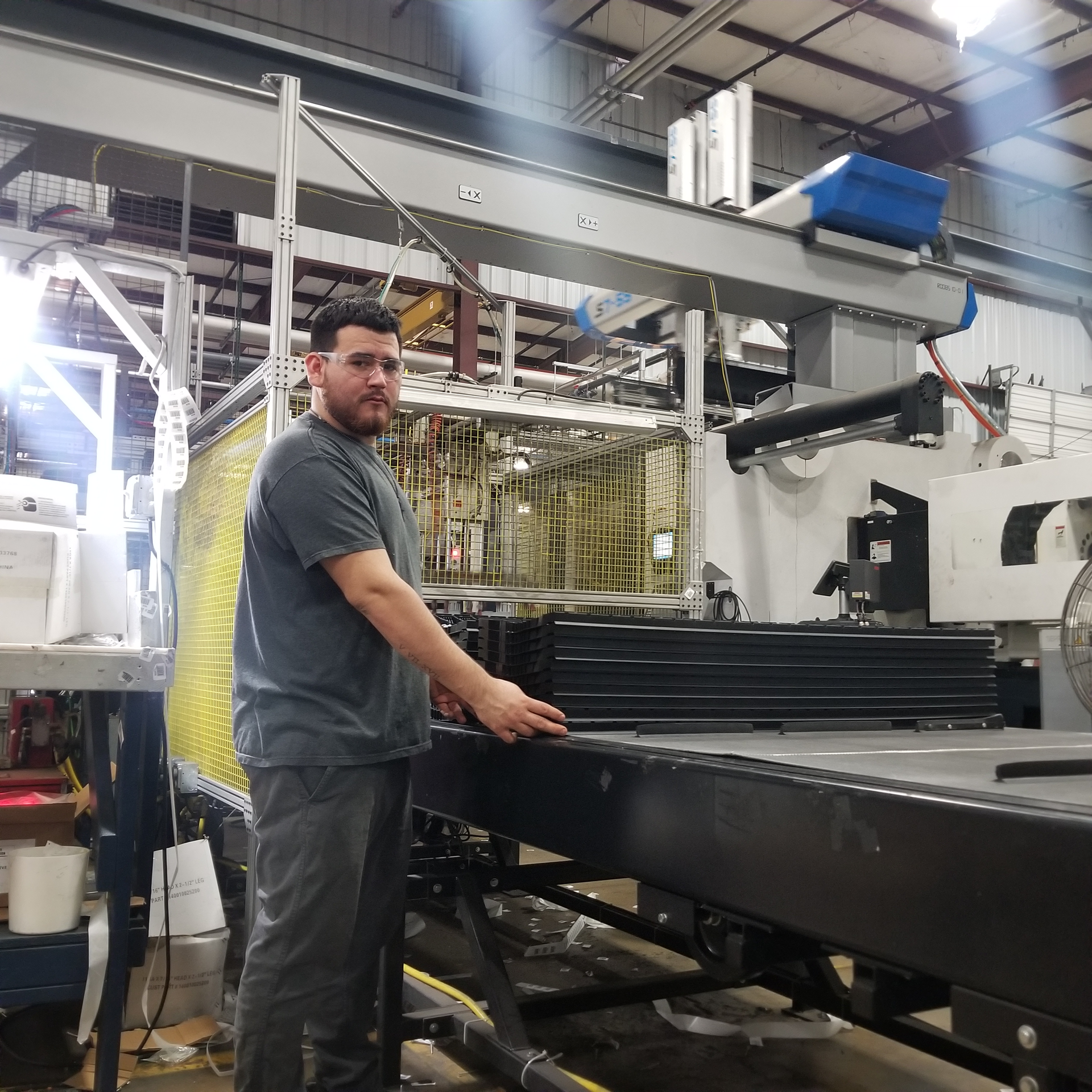 Production operator Tyler Cline receives stacks of parts at an ergonomic height in an automated production line.