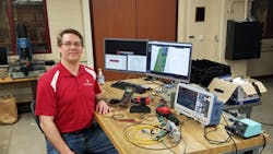 Erick Oberstar, a mechanical engineering faculty associate, sits in the University of Wisconsin's mechatronics laboratory, where a large portion of the work on powered air-purifying respirators was done. Erick Oberstar, a mechanical engineering faculty associate, sits in the University of Wisconsin's mechatronics laboratory, where a large portion of the work on powered air-purifying respirators was done.