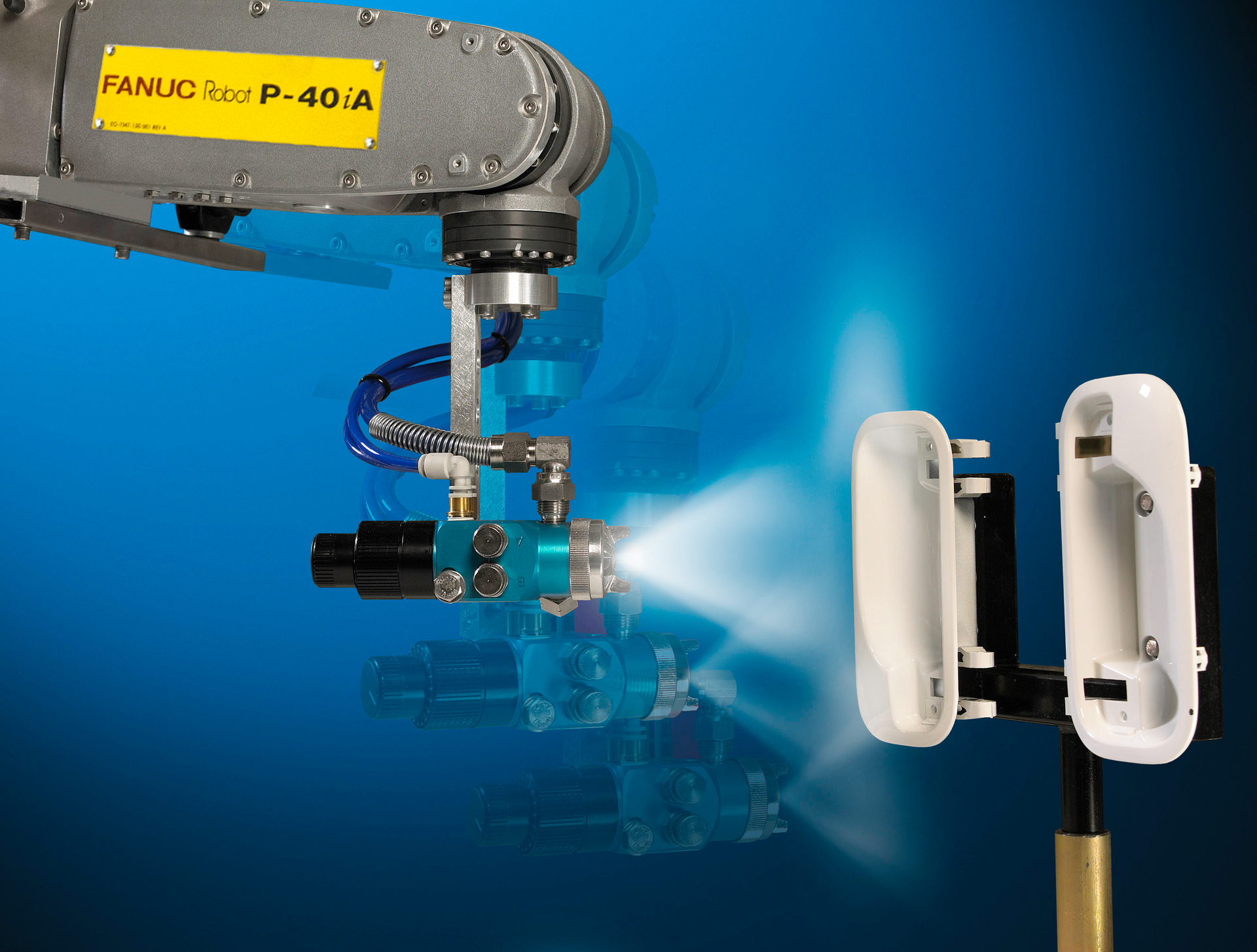 A Fanuc robot painting plastic parts