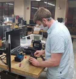 Assistant professor Josh Roth works on powered air-purifying respirator components in the University of Wisconsin's mechatronics laboratory. Assistant professor Josh Roth works on powered air-purifying respirator components in the University of Wisconsin's mechatronics laboratory.