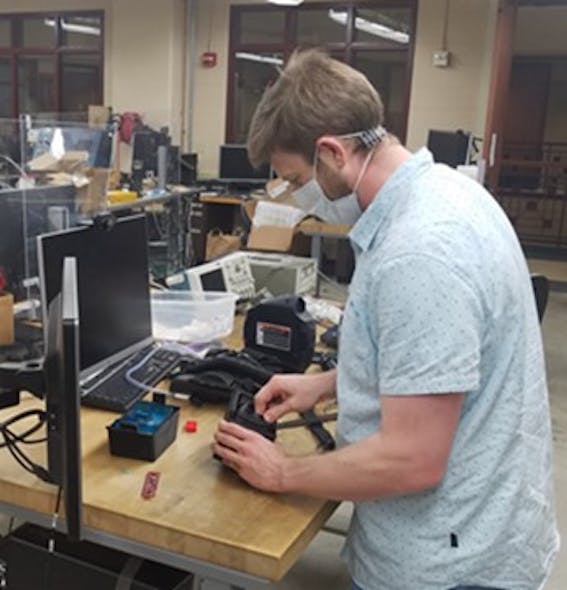 Assistant professor Josh Roth works on powered air-purifying respirator components in the University of Wisconsin&apos;s mechatronics laboratory.