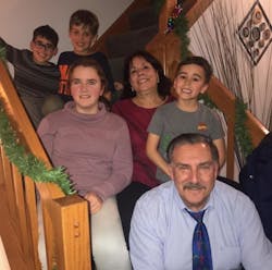Steve Petrakis, who is retiring in June, enjoys spending time with his family, fishing and boating on a lake outside his home. Shown on the row above him at Christmas 2019 are his grandchildren, Emma and Camden; his wife, Jane; and from left to right, on the top row, grandsons, Nathan and Lincoln.