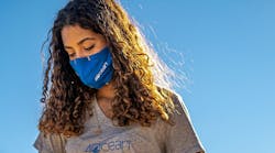 A woman sports a 4ocean shirt, face mask and face-mask frame. The products are part of the company&apos;s portfolio, with proceeds of sales spent on ocean cleanups.