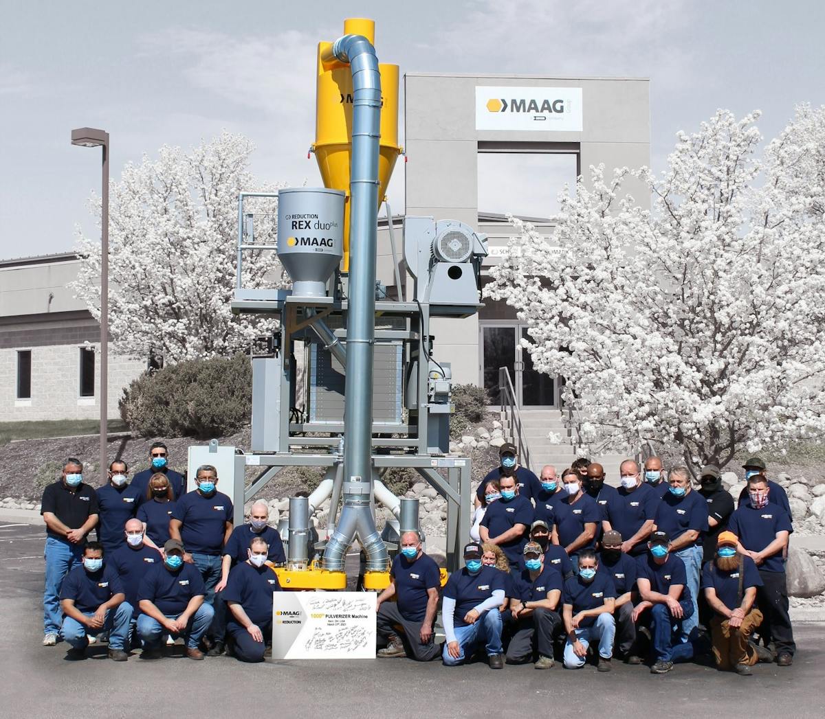 Maag Reduction employees stand near the 1,000th pulverizer produced at their facility in Kent, Ohio.
