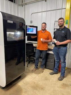 Chaz Winne, process engineer at PDS Plastics, left, works with Zack Demaray, head of operations, at the company&apos;s Arburg Freeformer.