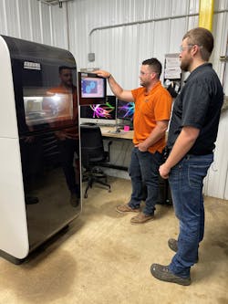 Chaz Winne, process engineer at PDS Plastics, left, works with Zack Demaray, head of operations, at the company's Arburg Freeformer. Chaz Winne, process engineer at PDS Plastics, left, works with Zack Demaray, head of operations, at the company's Arburg Freeformer.