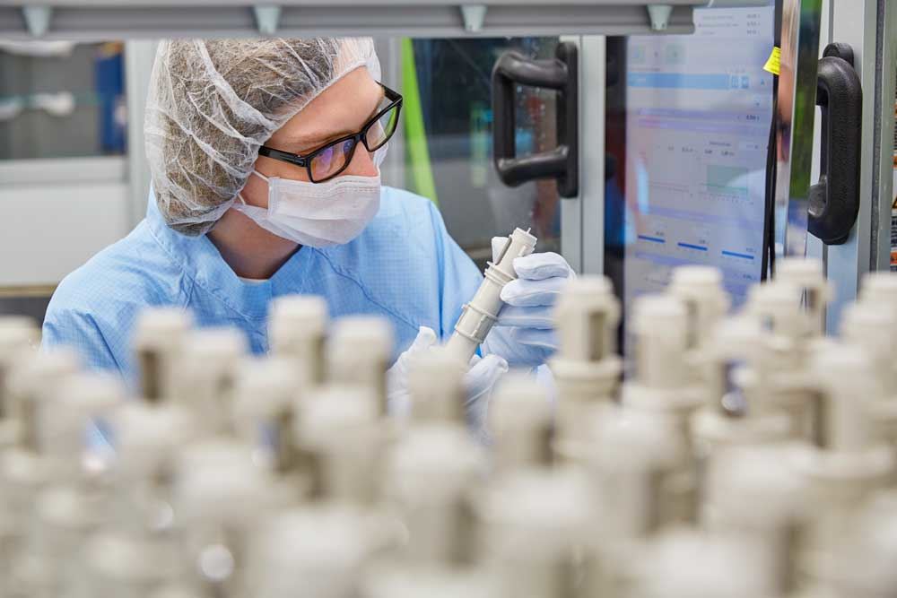 A Minnesota Rubber & Plastics employee looks over products.