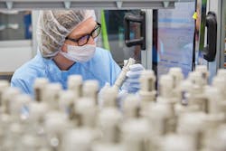 A Minnesota Rubber & Plastics employee looks over products. A Minnesota Rubber & Plastics employee looks over products.