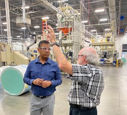 Kausik Dasgupta, VP of product and implementation for FactoryEye North America (left), discusses the implementation of the FactoryEye Solution with Aplix industrial engineer Bruce Gowan on the Aplix factory floor.