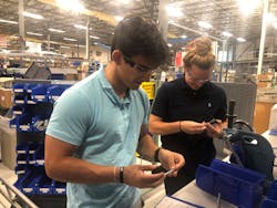 Mack sales and engineering interns Hayden Gallo and Nicole McCarvill work on a manufacturing line at the company&rsquo;s Arlington, Vt., headquarters.