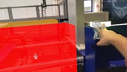 Wittmann Battenfeld software engineer Stefan Dietrich interacts with an injection molding machine using the HoloLens and HoloVoice augmented-reality platform. Wittmann Battenfeld software engineer Stefan Dietrich interacts with an injection molding machine using the HoloLens and HoloVoice augmented-reality platform.