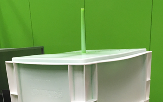 Engel's skinmelt process results in parts that have a recycled-material core, which is visible at the gate, as the green post-consumer recycled material is here.