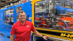 Steve Rocheleau with one of his company's extrusion blow molding machines.