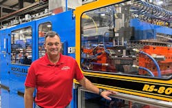 Steve Rocheleau with one of his company's extrusion blow molding machines. Steve Rocheleau with one of his company's extrusion blow molding machines.