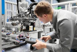 A technician looks over part of an automation cell set up by Arburg and NP Germany, an injection molder located in Brilon, Germany. A technician looks over part of an automation cell set up by Arburg and NP Germany, an injection molder located in Brilon, Germany.