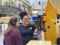 College senior Jovan Heusser, right, works with a classmate on an injection molding machine at Penn State Behrend. Heusser, who has been working from home for Currier Plastics, where she&apos;s also interned, will join the Auburn, N.Y., as a full-time engineer after graduation.