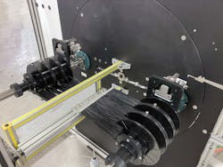 With the new feature, the coiler is programmed to wind one spool at a time until all the spools on one shaft are full. Then the coiler moves the shaft with empty spools into position. With the new feature, the coiler is programmed to wind one spool at a time until all the spools on one shaft are full. Then the coiler moves the shaft with empty spools into position.