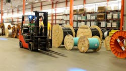 A forklift truck operates inside Corning&apos;s Hickory, N.C., plant, where the company is relying on a 5G network to create the fiber optic cable that carries 5G signals to others.
