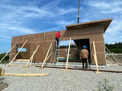 Workers put up an Ecoplast home, which will feature foam cores made from recycled PET bottles. Because the home is fabricated at a plant, then assembled on-site, the framing process takes only a day or two.