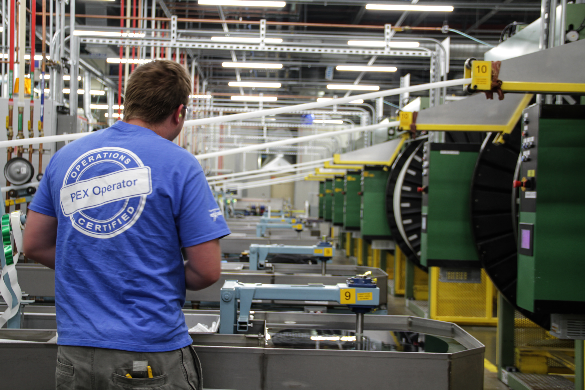A worker oversees operations at one of Uponor's pipe-manufacturing facilities.