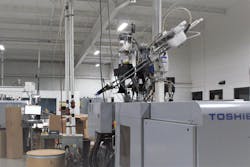 A Toshiba press churns out parts at Pyramid Plastics. A Toshiba press churns out parts at Pyramid Plastics.