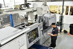 A Yushin robot is stationed above a press at Pyramid Plastics, which has been investing in new automation. A Yushin robot is stationed above a press at Pyramid Plastics, which has been investing in new automation.