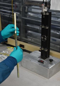 A Teel Plastics employee uses a custom-designed setup to perform quality control.