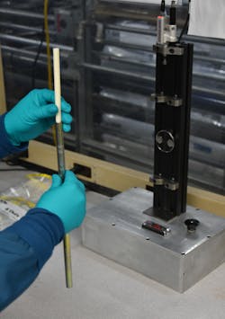 A Teel Plastics employee uses a custom-designed setup to perform quality control. A Teel Plastics employee uses a custom-designed setup to perform quality control.