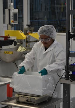 A Teel Plastics employee works in a clean room. A Teel Plastics employee works in a clean room.