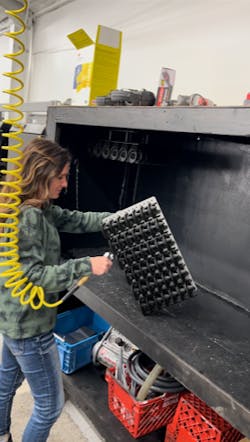 A Merit3D worker works with parts for promotional pens after they've been printed. A Merit3D worker works with parts for promotional pens after they've been printed.