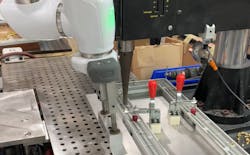 At Ferriot Inc., a tray fabricated by the company's automation department holds a plastic part, and is guided under an ultrasonic welder by a cobot. After each metal insert is joined to the part by the welder, the cobot repositions the tray for the next weld to be made. At Ferriot Inc., a tray fabricated by the company's automation department holds a plastic part, and is guided under an ultrasonic welder by a cobot. After each metal insert is joined to the part by the welder, the cobot repositions the tray for the next weld to be made.