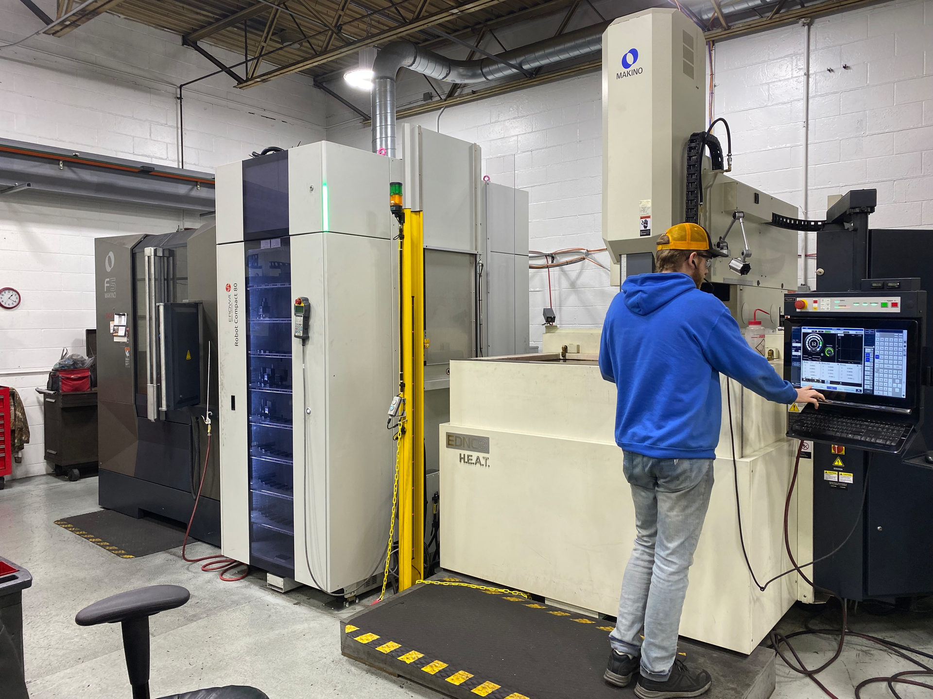 An employee works at an electrical discharge machining cell at Decatur Mold Tool & Engineering Inc., which is expanding in the hopes that the addition of automation can make it more globally competitive.