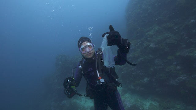 Fisk Johnson, chairman and CEO of SC Johnson, holds up a piece of plastic pollution he found in the water off Bali, Indonesia.