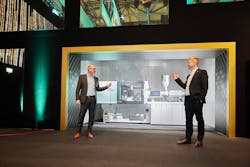 Arburg&apos;s Guido Frohnhaus, left, managing director for technology and engineering, and Gerhard B&ouml;hm, managing director for sales and service, introduce the company&apos;s hybrid Allrounder 470 H machines in February at a company event.