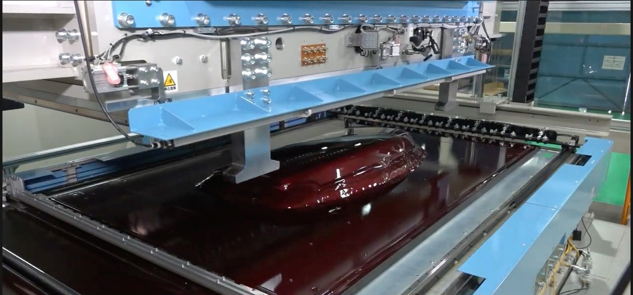 The Ultra-Wide TOM Machine from Japanese equipment manufacturer Fu-se Vacuum Forming Co. Ltd. provides an automated method for applying Aero films to large parts, such as body panels.