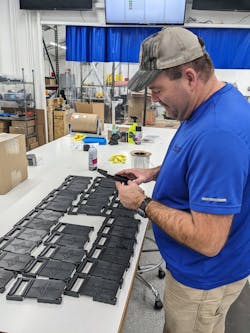 Justin Slaughter looks over parts produced by 3D printers at Merit3D. Justin Slaughter looks over parts produced by 3D printers at Merit3D.