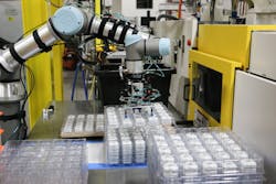 A Universal Robot UR5e picks up a tray of products at Aim Processing. A Universal Robot UR5e picks up a tray of products at Aim Processing.