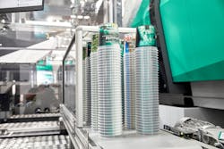 An Arburg work cell with a Brink mold and robot demonstrated injection-compression molding of thin-wall cups at K 2022 and Arburg Anniversary Days. An Arburg work cell with a Brink mold and robot demonstrated injection-compression molding of thin-wall cups at K 2022 and Arburg Anniversary Days.