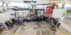 The team that contributed on the conception, design, assembly, testing and transport of a huge new 8,200-ton injection molding machine stand in front of it at the Engel plant where it was made in St. Valentin, Austria. The team that contributed on the conception, design, assembly, testing and transport of a huge new 8,200-ton injection molding machine stand in front of it at the Engel plant where it was made in St. Valentin, Austria.