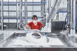 A Voxeljet technician unpacks a large polymer impeller prototype from the VX1000 HSS 3D jobbox -- the tray that makes up the company's new printer's build space. A Voxeljet technician unpacks a large polymer impeller prototype from the VX1000 HSS 3D jobbox -- the tray that makes up the company's new printer's build space.